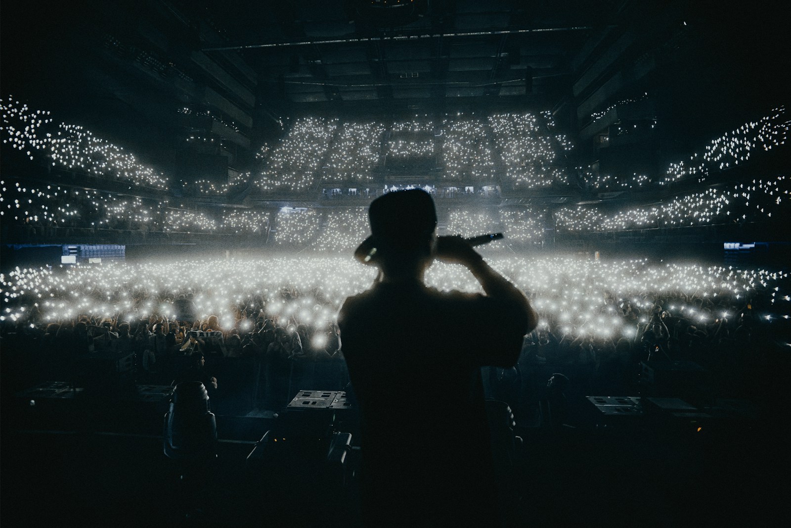 A person standing in front of a stage with a microphone